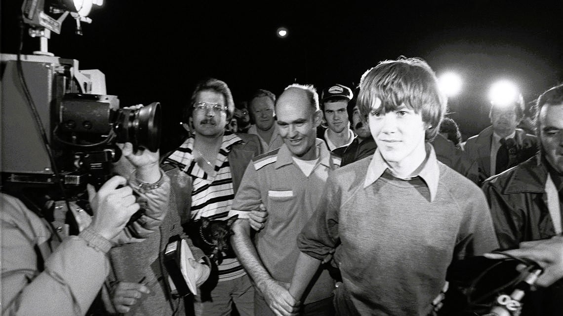 Steven Stayner freed from captivity in 1980 - Cary Stayner in background wearing cap